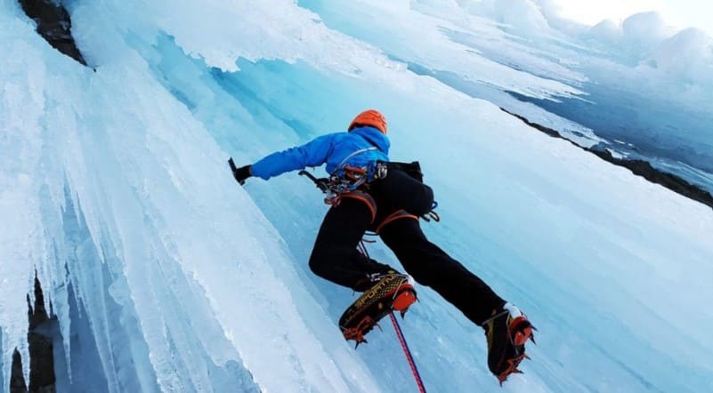 escalador ascendiendo sobre un muro de hielo